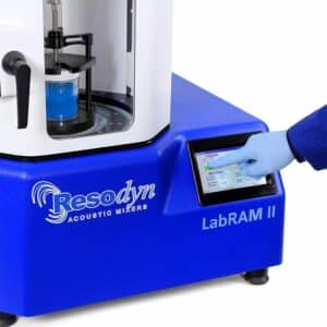 A hand wearing a glove pressing buttons on the LabRAM II